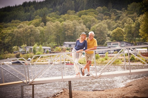 Couple enjoy views from the jetty at Loch Lomond