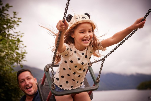 Child playing on the swing at the Play Park at Loch Lomond