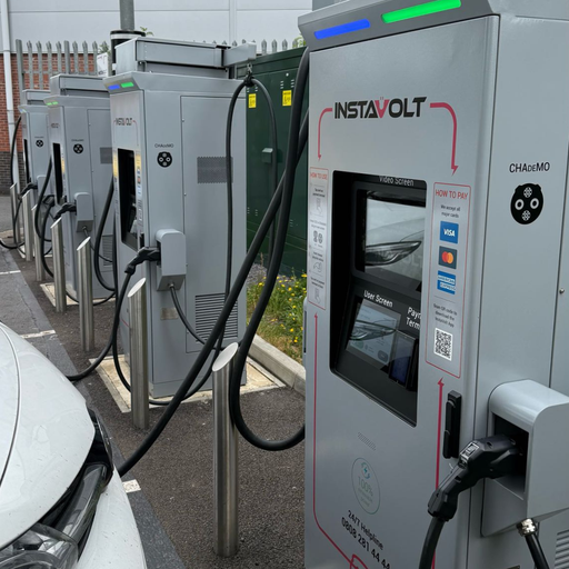 Close-up of InstaVolt ultra rapid chargers in use at Four Pools Retail Park, Evesham, with a vehicle plugged in and charging.