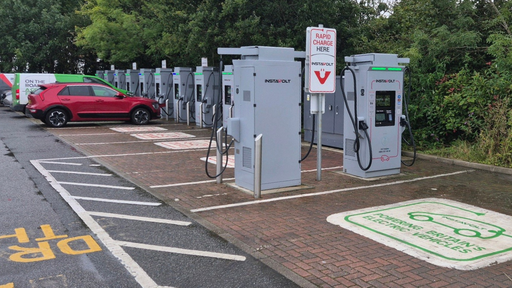 View of InstaVolt charging bays at Bodmin Retail Park, with EVs plugged in and clear signage visible.