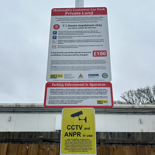 Parking terms and conditions signage at the McDonald’s car park, including maximum stay details and CCTV and ANPR enforcement information.
