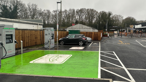 Wide view of InstaVolt EV charging bays at a McDonald’s location, showing clearly marked green electric vehicle spaces and easy access from the car park.