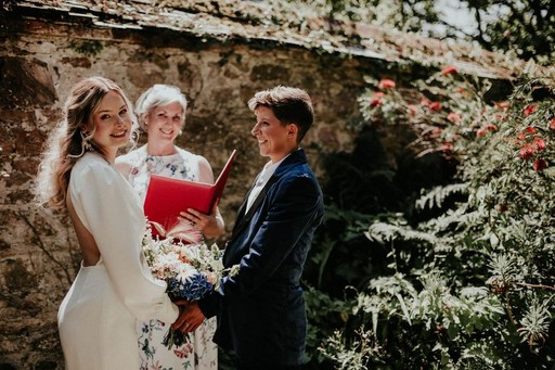 Sara Price Celebrant with a same sex couple during an outdoor ceremony in the garden