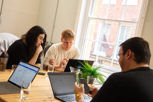 Team members of Dynamize Group working together. 